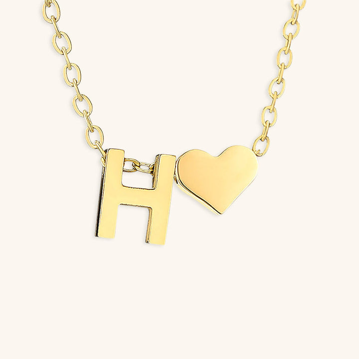 navnesmykke med initialen Ria | 18k Guld